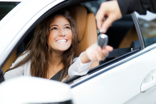 Woman receiving the keys to her car