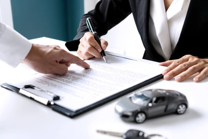 Person signing additional insurance documents.