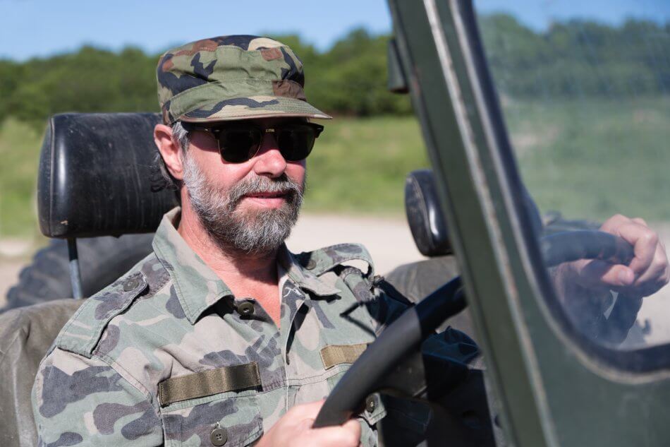 Veteran behind the wheel of a topless jeep. Car shipping for Military personnel.
