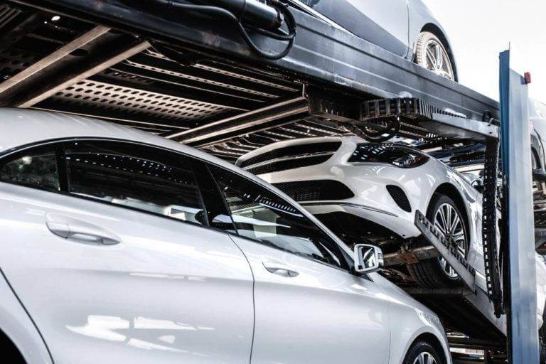 Cars snug on an auto transport carrier trailer, shipping a vehicle.