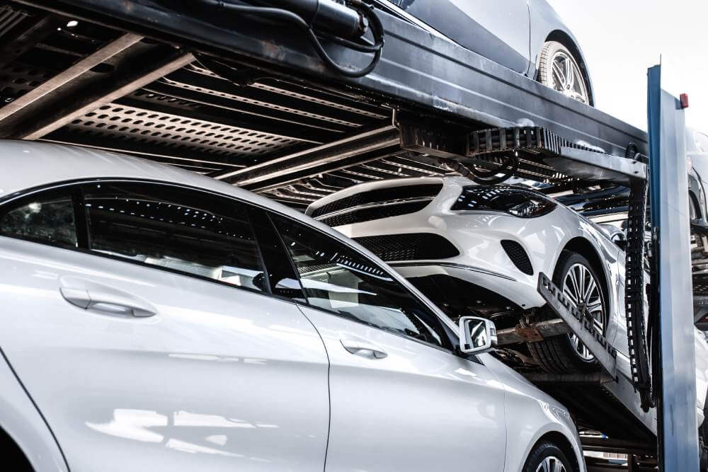 Cars snug on an auto transport carrier trailer, shipping a vehicle.