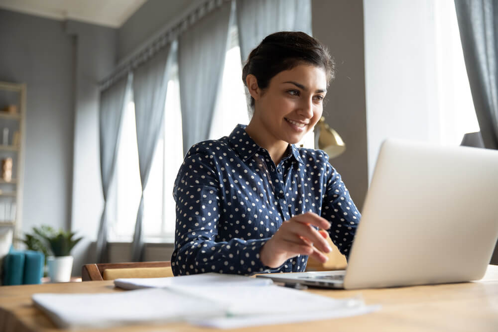 A woman checks reviews on her laptop. Auto transport companies.