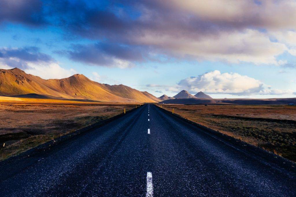 A view of a wide-open road that goes on for miles. Cost to ship cars.