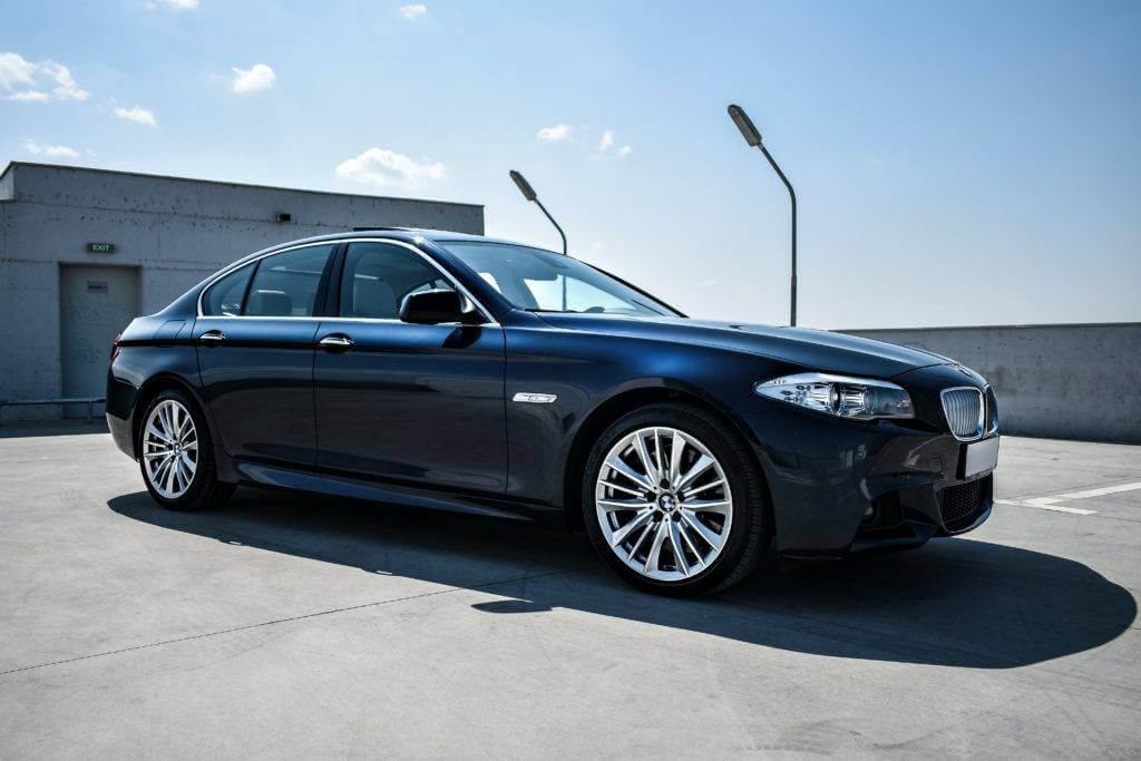 A 4-door sedan parked in a parking lot. Need to ship a car? Get a car shipping quote from NTS today.