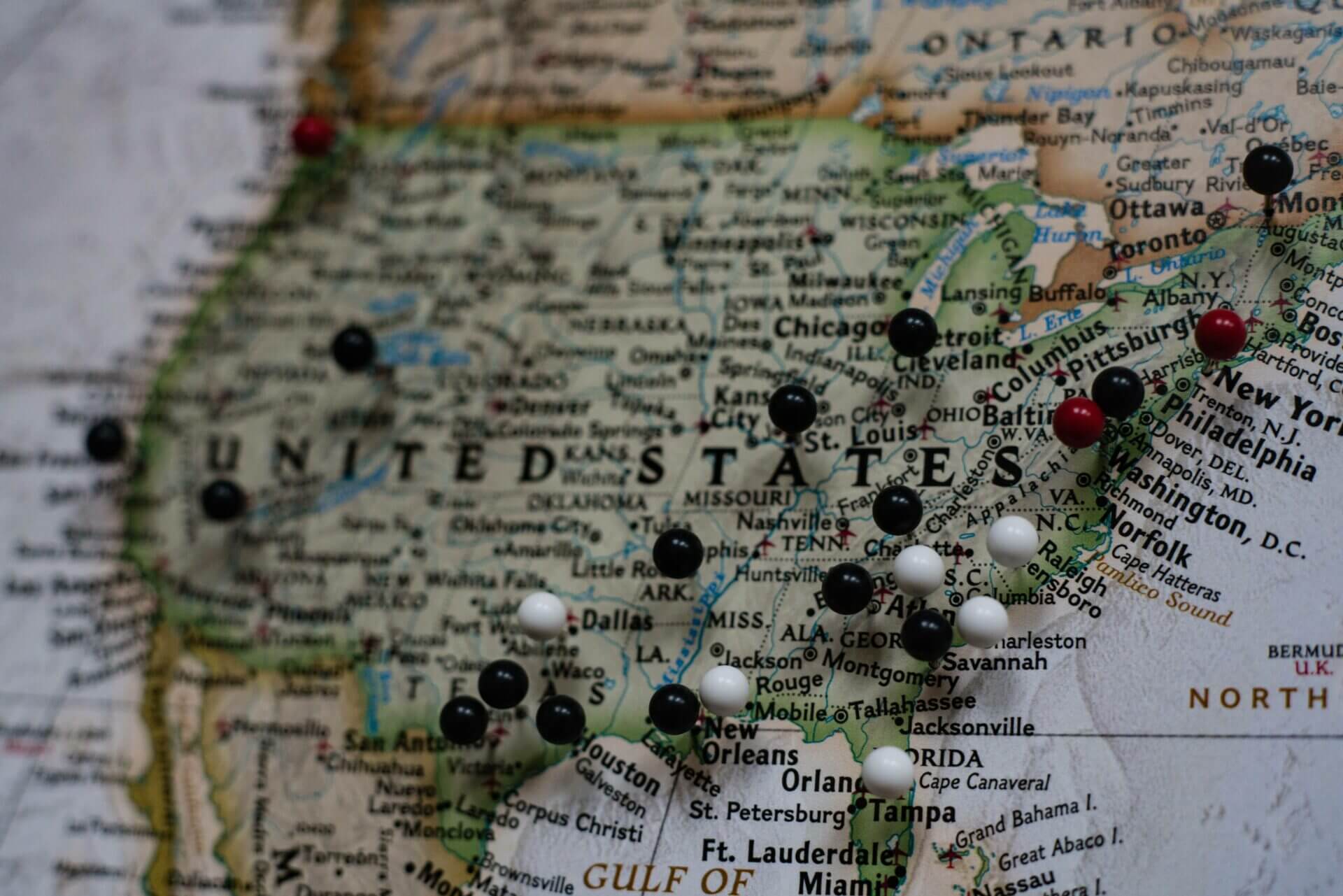 A map of the United States with black, white, and red pins. Want to ship a car to another state? National Transport Services are the experts in shipping a car to another state.