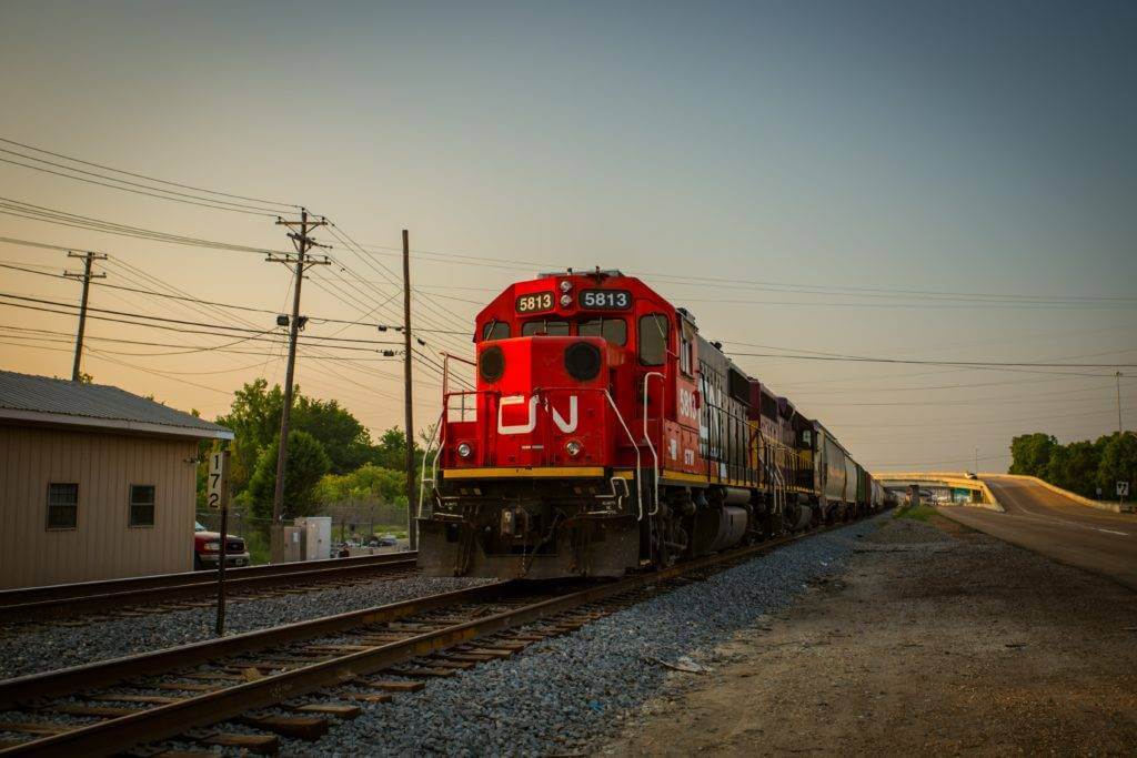 Red Train with the sunsetting in the distance.